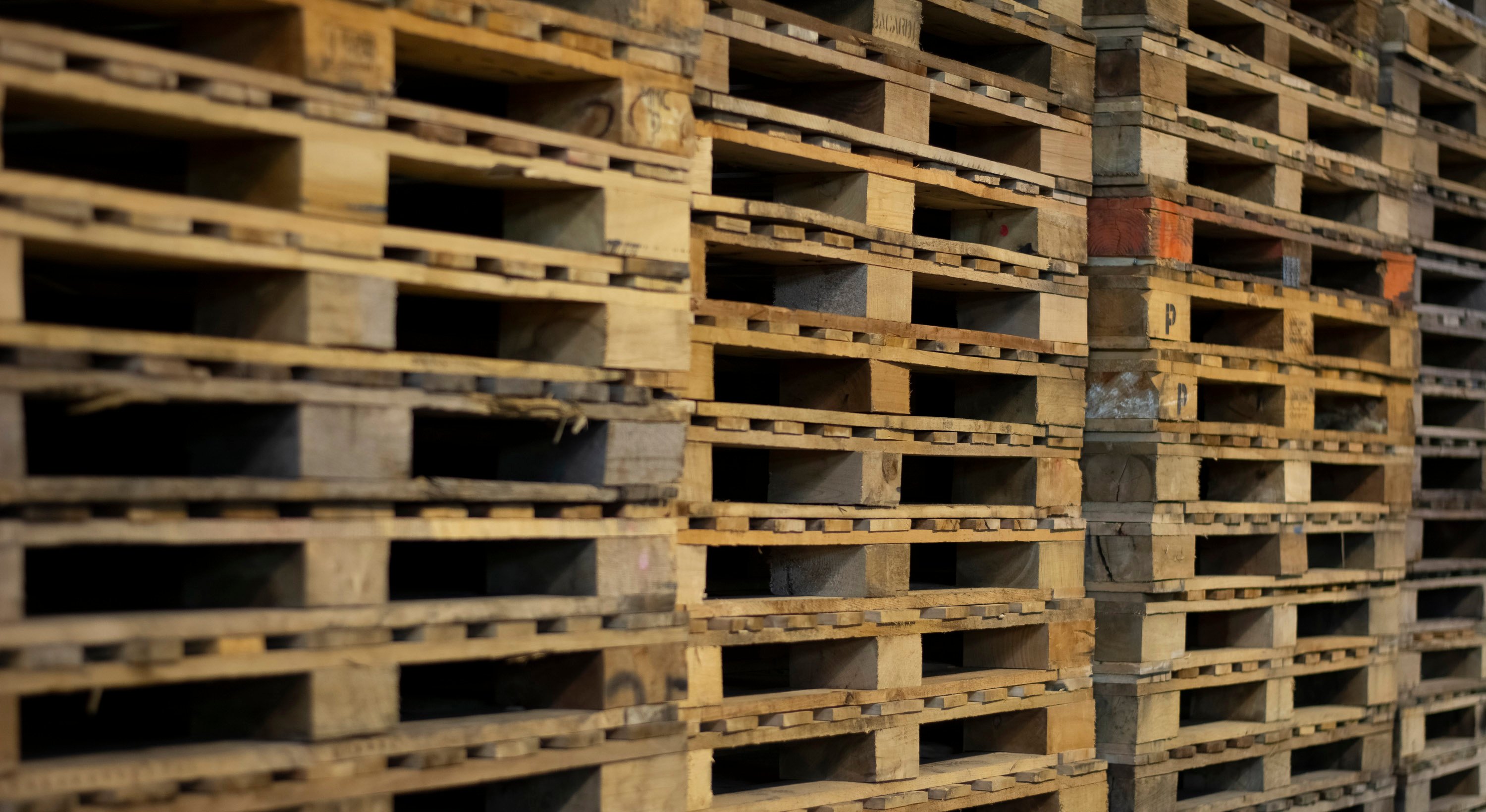 stacks of recycled white wood pallets